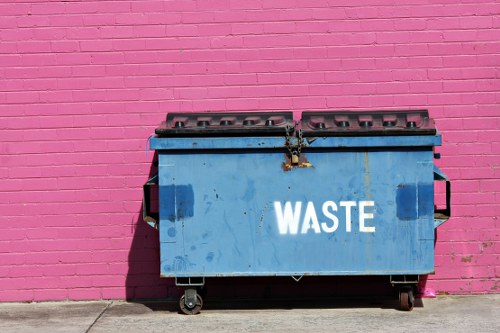Eco-friendly skip hire vehicles outside a collection point